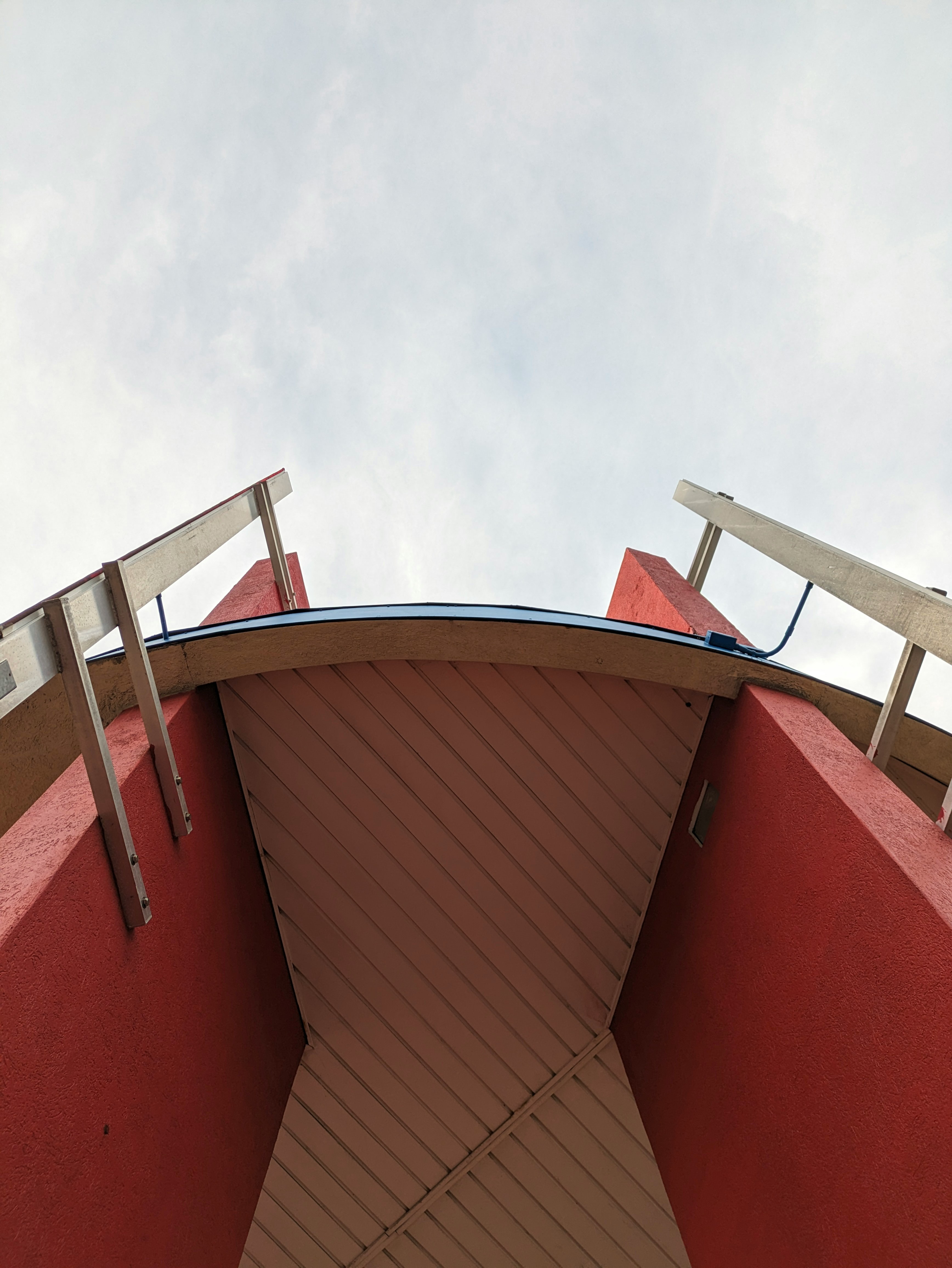a primarily red building seen from the ground